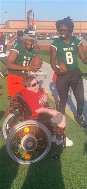 Cypress Falls HS football players cheer a Cy Woods student at Camp Courage.